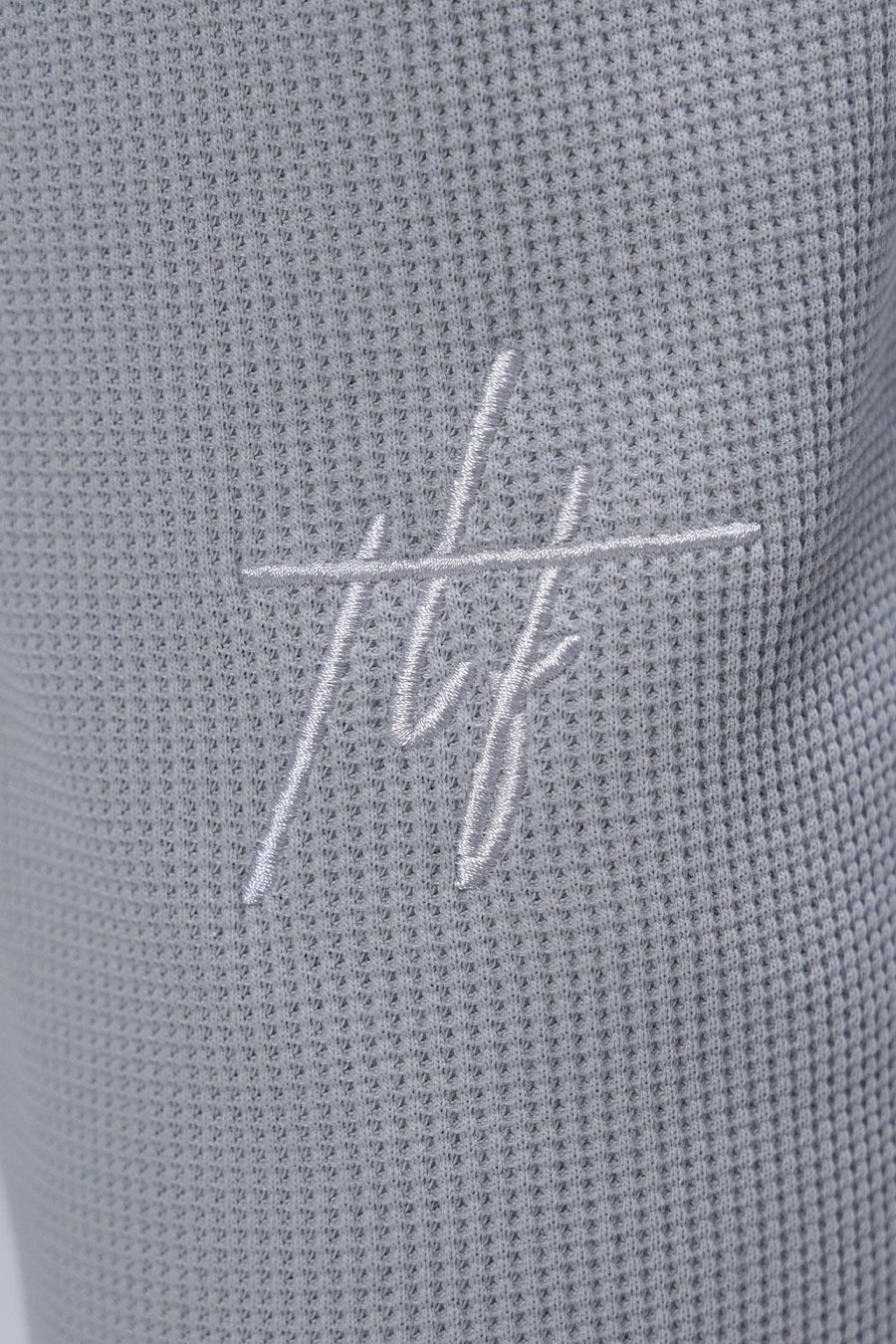 Detail Back View of Gray TLF Elevate Waffle Tech Joggers, featuring an athletic relaxed fit with zipper pockets designed for all day wear