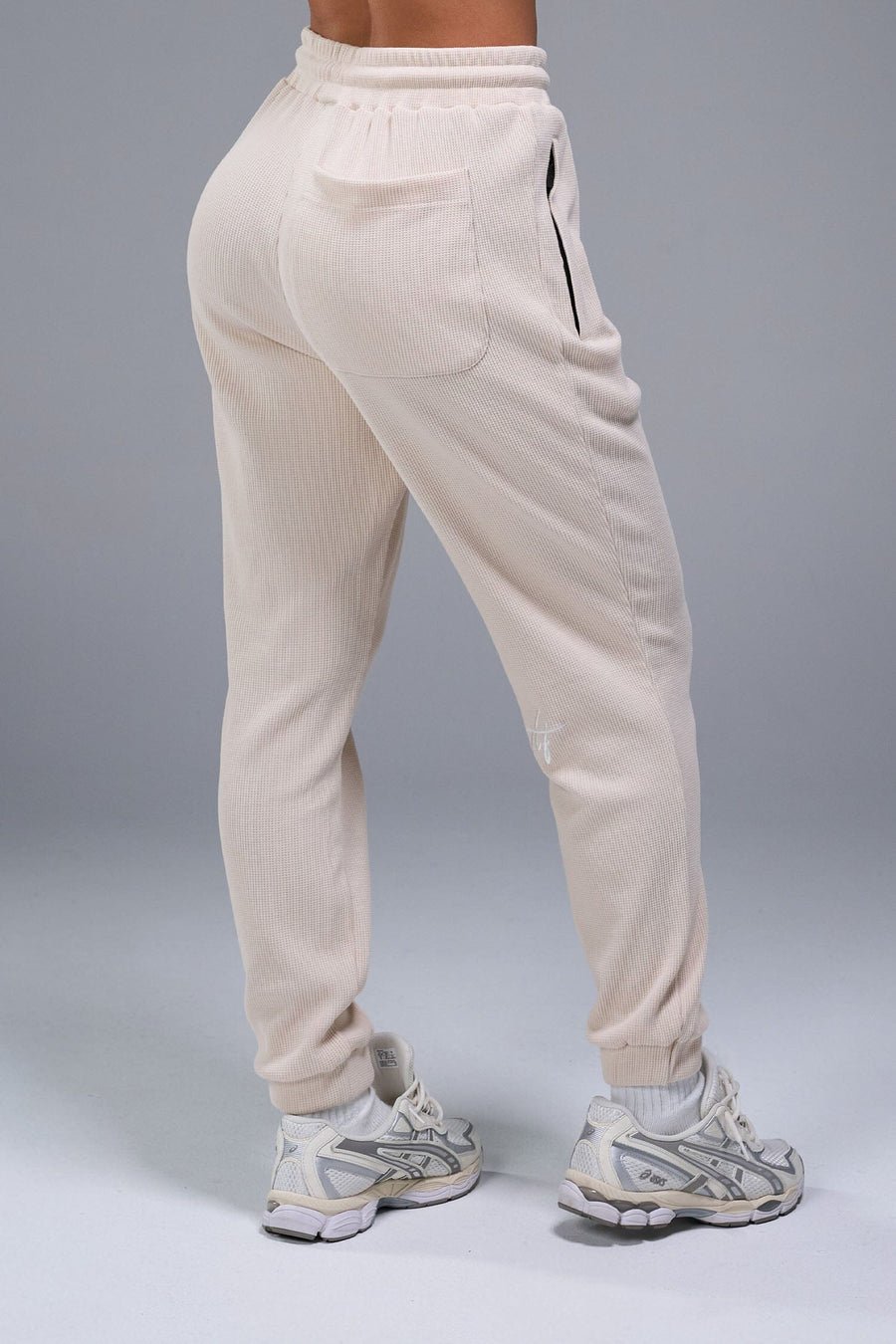 Back side View of White TLF Elevate Waffle Tech Joggers, featuring an athletic relaxed fit with zipper pockets designed for all day wear