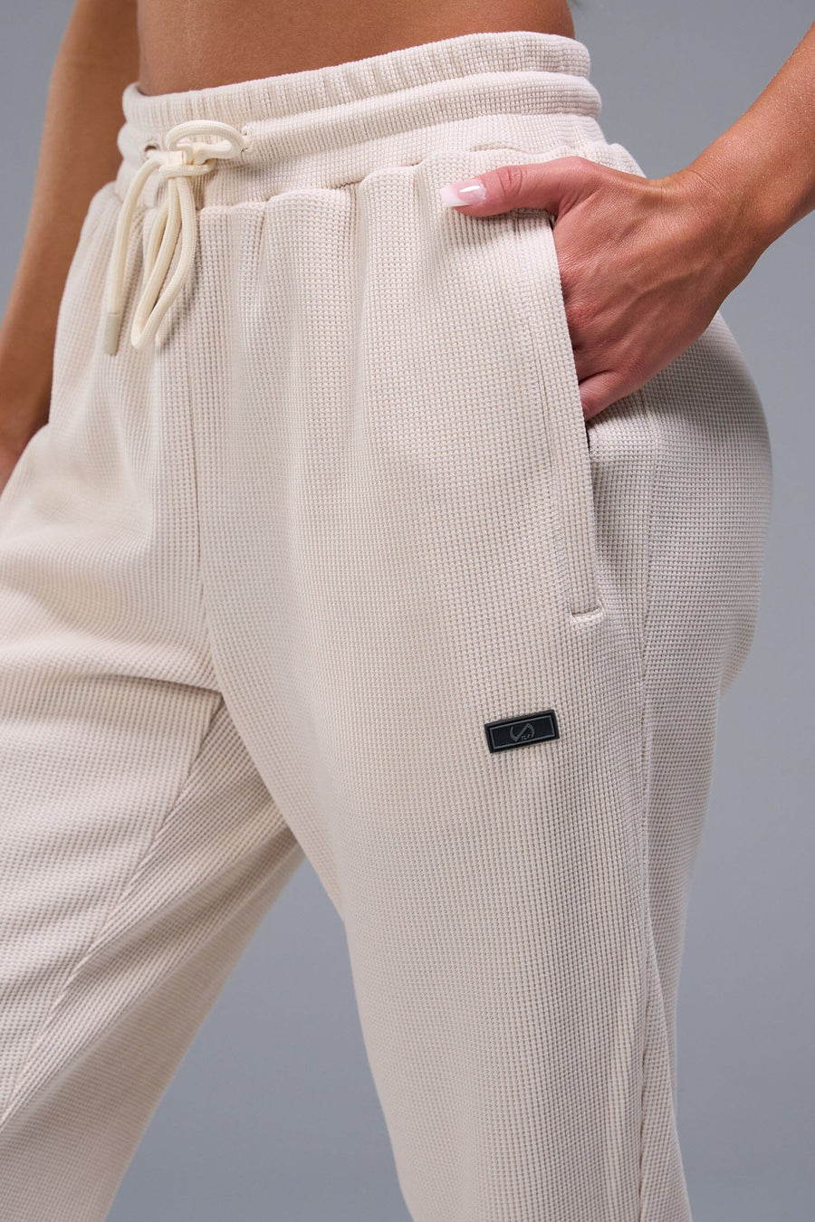 Detail Front View of White TLF Elevate Waffle Tech Joggers, featuring an athletic relaxed fit with zipper pockets designed for all day wear