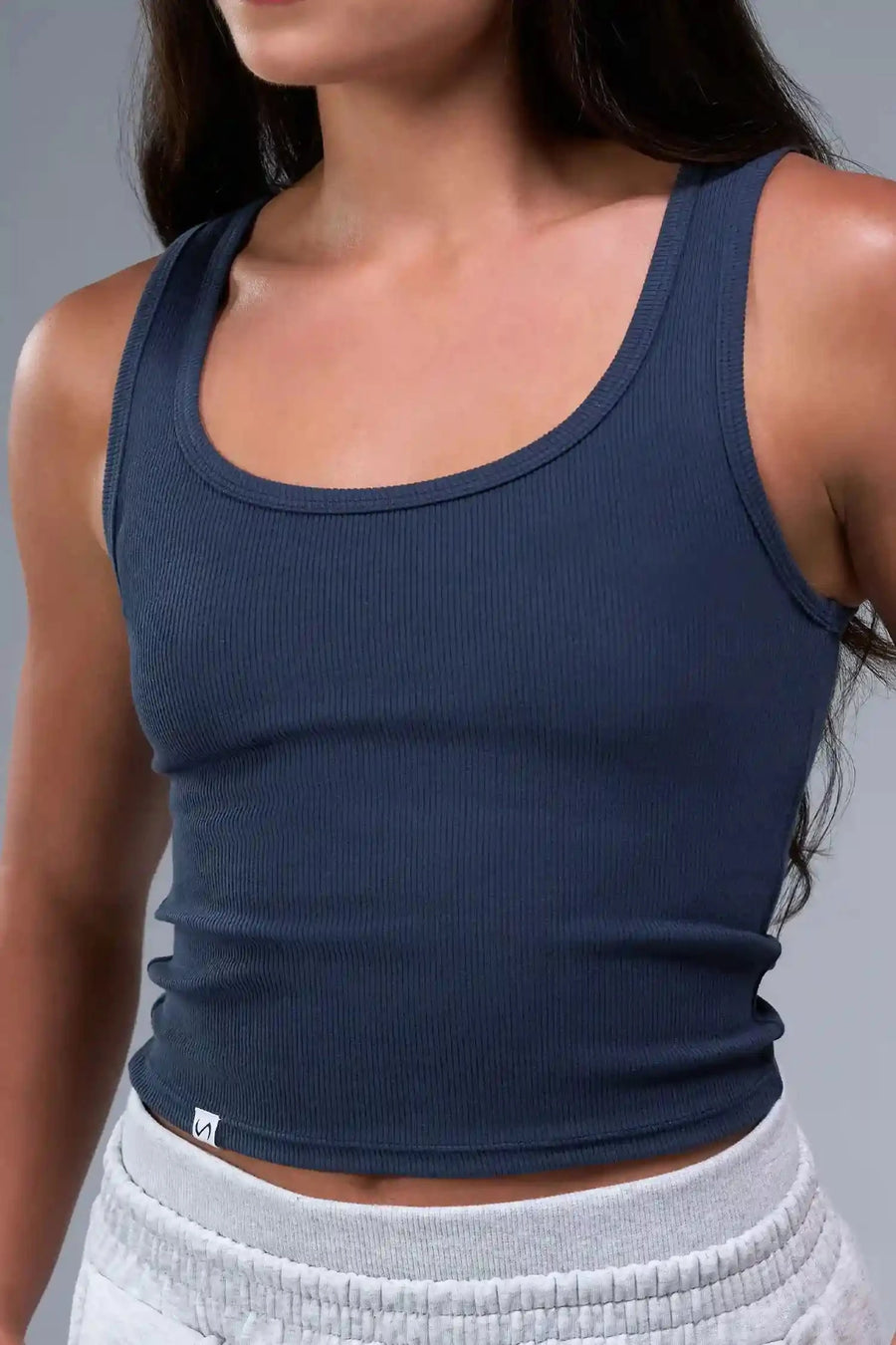 Front View of Blue TLF Essential Ribbed Tank Top, featuring a scoop neckline in our ribbed tech fabric