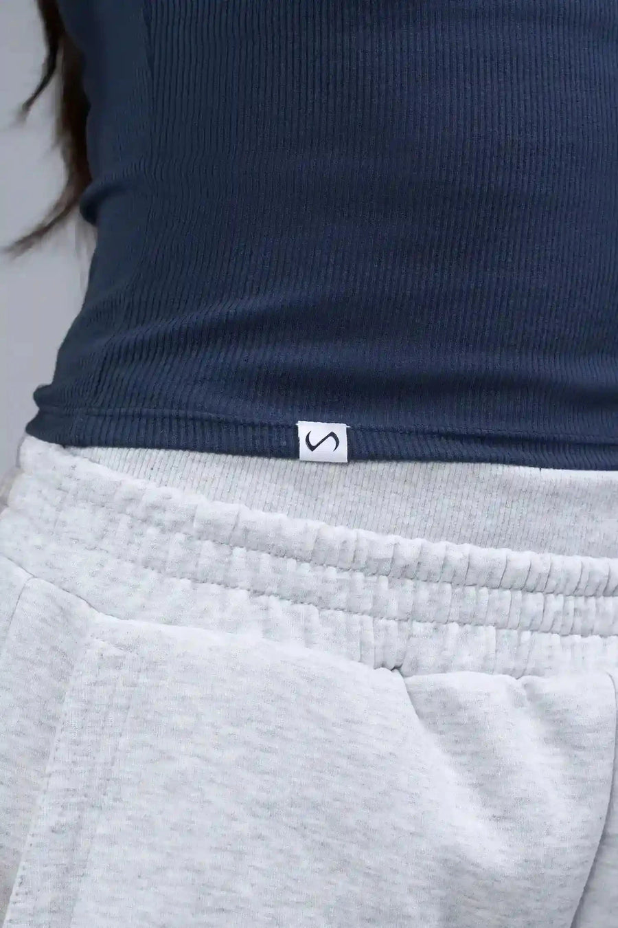 Detail Logo View of Blue TLF Essential Ribbed Tank Top, featuring a scoop neckline in our ribbed tech fabric