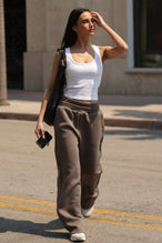 Front View of White TLF Essential Ribbed Tank Top, featuring a scoop neckline in our ribbed tech fabric 