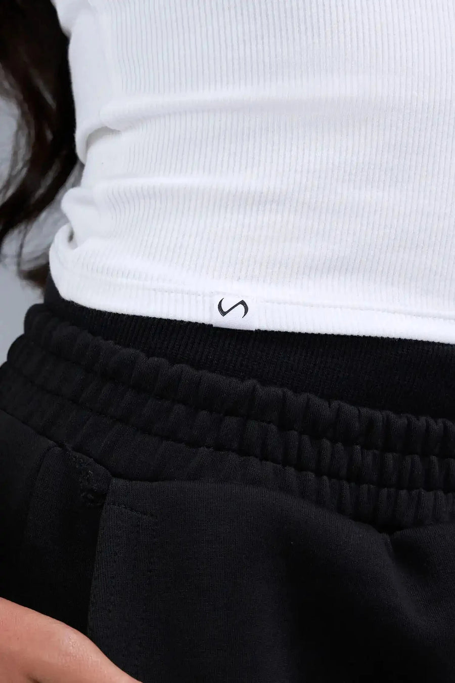 Detail Front View of White TLF Essential Ribbed Tank Top, featuring a scoop neckline in our ribbed tech fabric 
