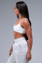 Side View of White TLF Essential Scrunch Seamless Bralette, featuring adjustable straps for a custom fit and scrunch front design 