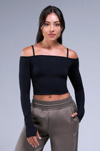 Front View of Black TLF Essential Scrunch Seamless Bralette wearing under the Essential Seamless Off The Shoulder Top, featuring adjustable straps for a custom fit and scrunch front design 