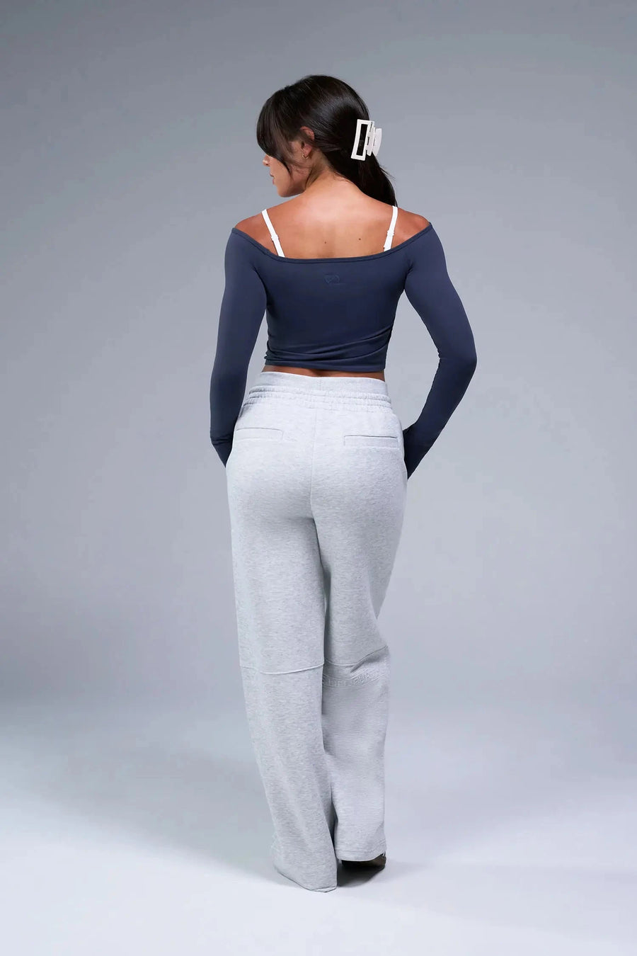 Back View of Blue TLF Essential Seamless off the shoulder top, featuring a cropped length and thumbholes 