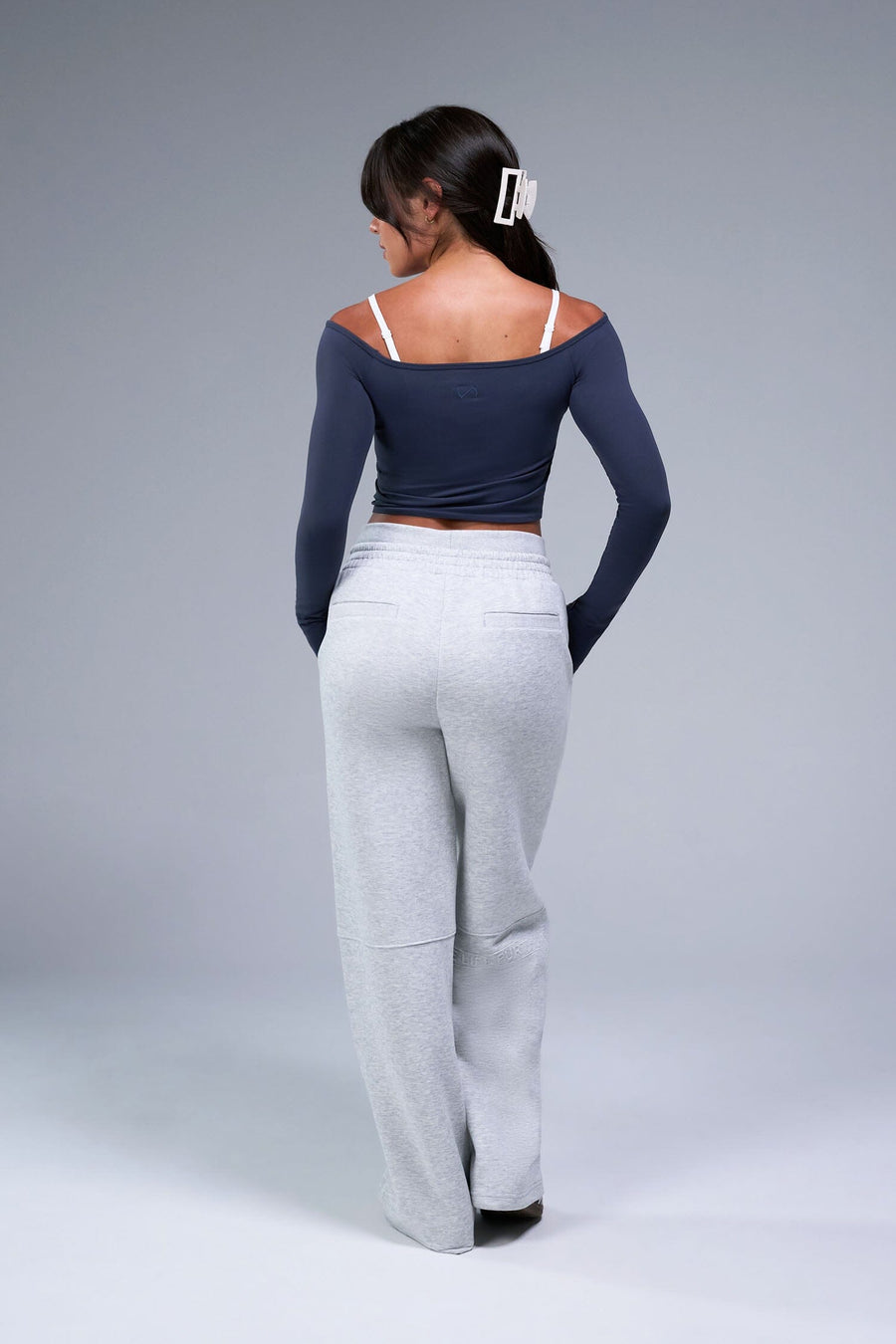 Back View of Blue TLF Essential Seamless off the shoulder top, featuring a cropped length and thumbholes 