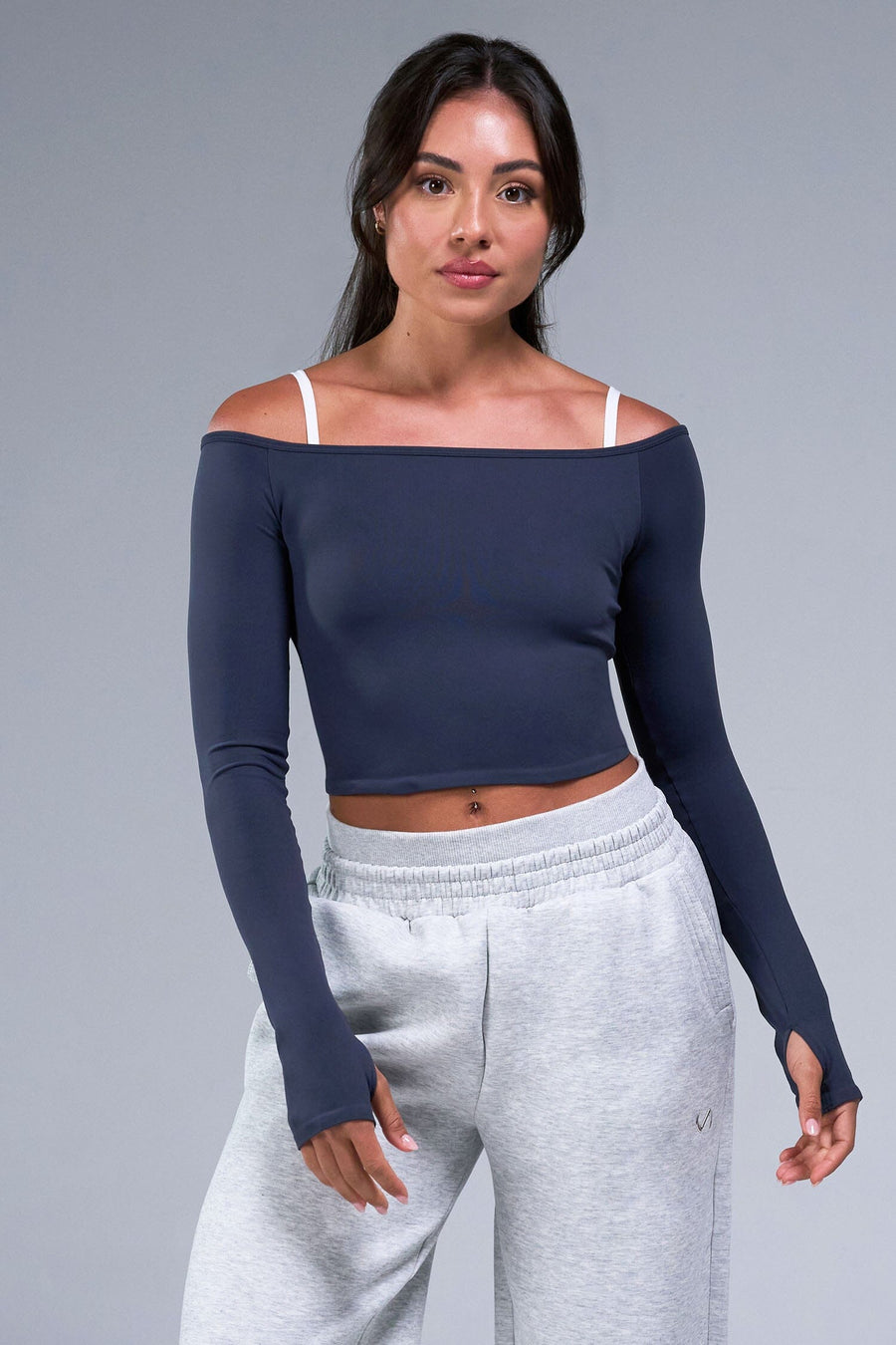 Front View of Blue TLF Essential Seamless off the shoulder top, featuring a cropped length and thumbholes 