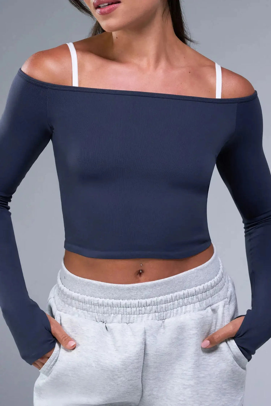 Front View of Blue TLF Essential Seamless off the shoulder top, featuring a cropped length and thumbholes 