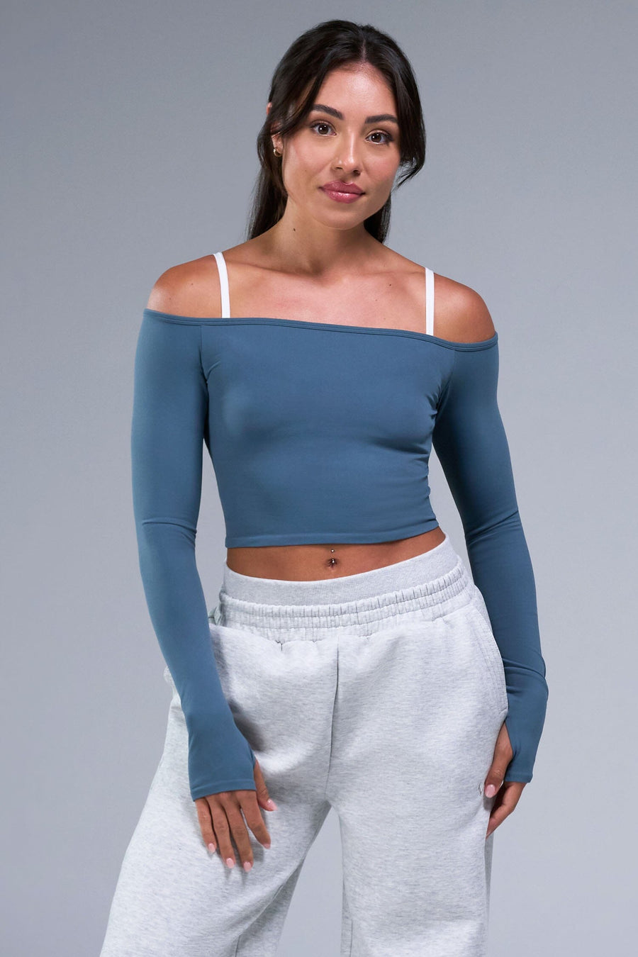 Front View of Blue TLF Essential Seamless off the shoulder top, featuring a cropped length and thumbholes 