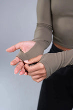 Detail Sleeves View of Brown TLF Essential Seamless off the shoulder top, featuring a cropped length and thumbholes 