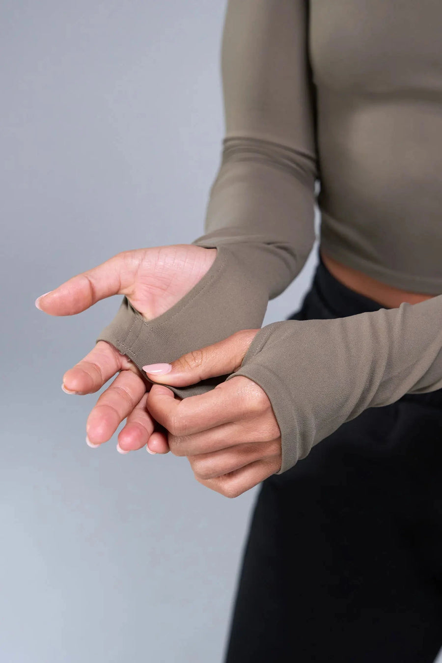 Detail Sleeves View of Brown TLF Essential Seamless off the shoulder top, featuring a cropped length and thumbholes 