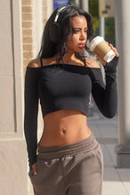 Front View of Black TLF Essential Seamless off the shoulder top, featuring a cropped length and thumbholes 