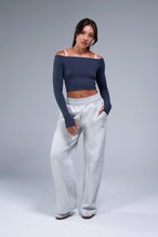 Front View of Blue TLF Essential Seamless off the shoulder top, featuring a cropped length and thumbholes 