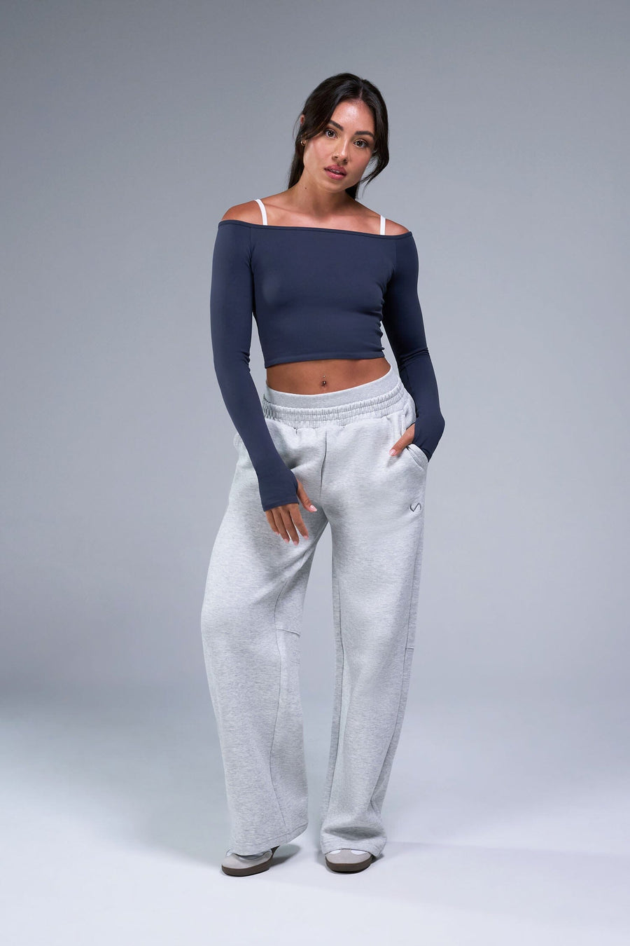 Front View of Blue TLF Essential Seamless off the shoulder top, featuring a cropped length and thumbholes 