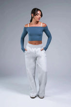 Front View of Blue TLF Essential Seamless off the shoulder top, featuring a cropped length and thumbholes 