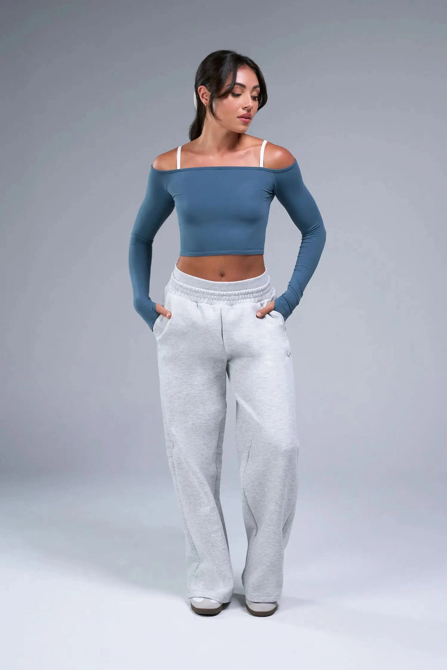 Front View of Blue TLF Essential Seamless off the shoulder top, featuring a cropped length and thumbholes 