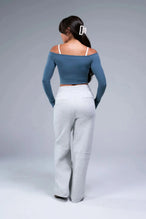 Back View of Blue TLF Essential Seamless off the shoulder top, featuring a cropped length and thumbholes 