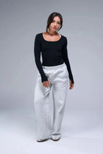 Front View of Black TLF Essential Seamless Reversible Scoop Neck, featuring thumbholes and multi wear for boat neck or scoop neck styling 