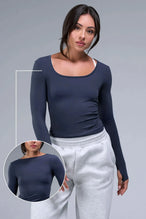 Front View of Blue TLF Essential Seamless Reversible Scoop Neck, featuring thumbholes and multi wear for boat neck or scoop neck styling 