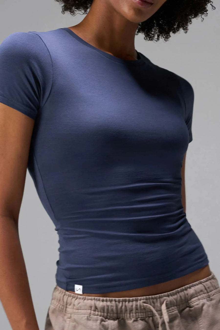 Front View of Blue the TLF Fitted Crew Neck T-Shirt featuring a long line silhouette and whip stitch detailing. 