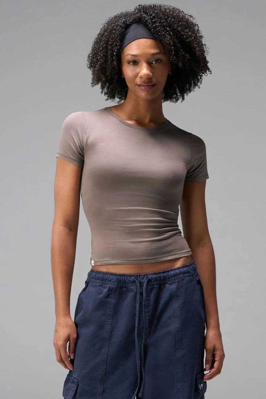 Front View of Brown the TLF Fitted Crew Neck T-Shirt featuring a long line silhouette and whip stitch detailing. 