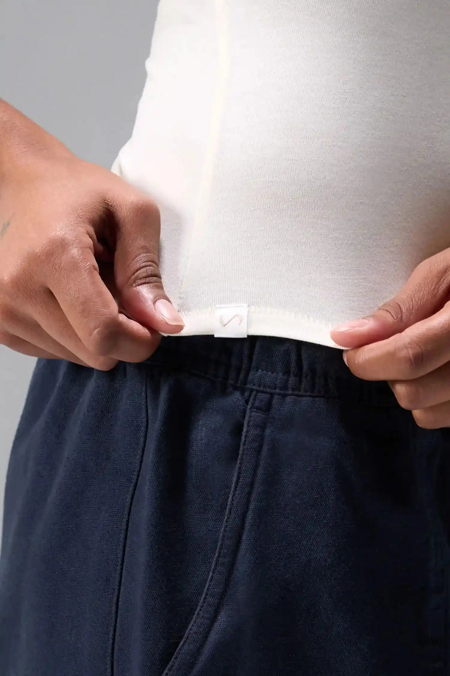 Front View of White the TLF Fitted Crew Neck T-Shirt featuring a long line silhouette and whip stitch detailing. 