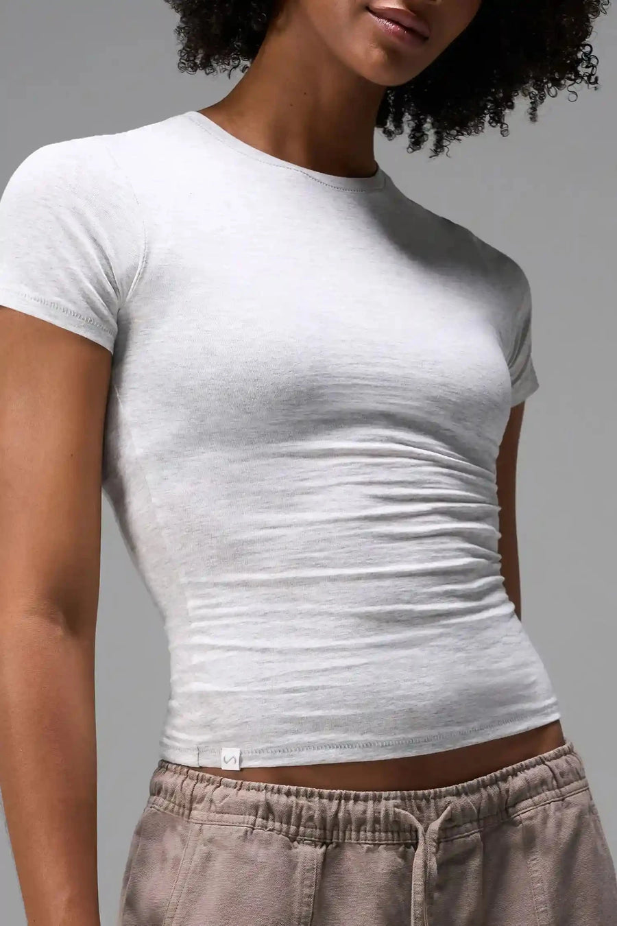 Front View of Gray the TLF Fitted Crew Neck T-Shirt featuring a long line silhouette and whip stitch detailing. 