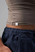 Side View of Brown the TLF Fitted Crew Neck T-Shirt featuring a long line silhouette and whip stitch detailing. 
