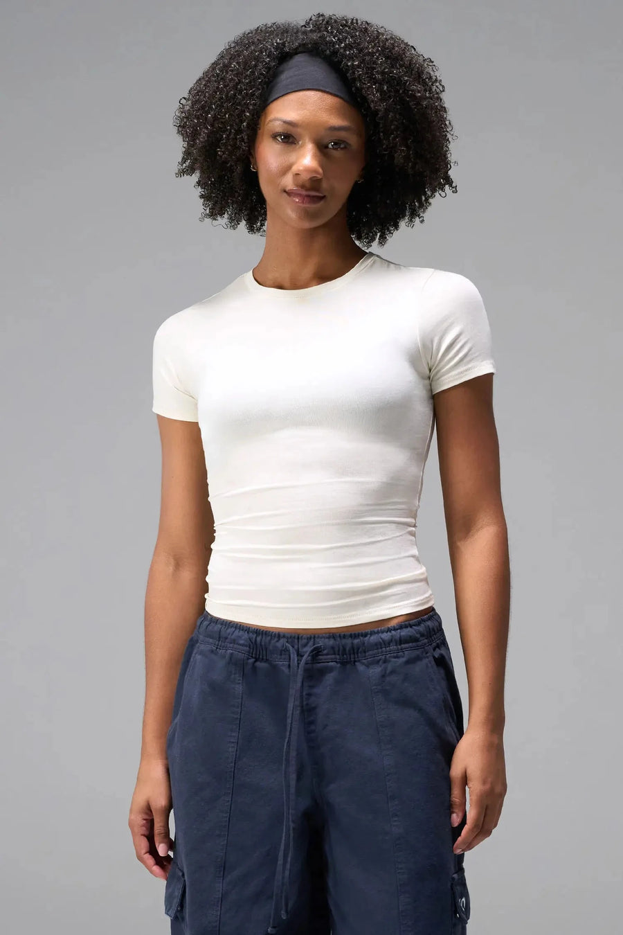 Front View of White the TLF Fitted Crew Neck T-Shirt featuring a long line silhouette and whip stitch detailing. 