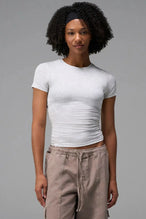 Side View of Gray the TLF Fitted Crew Neck T-Shirt featuring a long line silhouette and whip stitch detailing. 