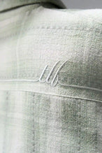 Detail View of the Green TLF Flannel Shacket featuring premium embroidery details on the collar and back in a cotton plaid flannel fabric