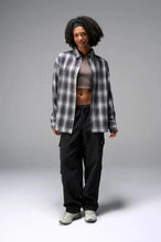 Front View of the Black TLF Flannel Shacket featuring premium embroidery details on the collar and back in a cotton plaid flannel fabric