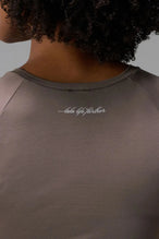 Back View of Brown the TLF GTS Cropped Baby Tee features sporty raglan sleeves, cropped length and premium whip stitch detailing. 