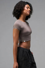 Side View of Brown the TLF GTS Cropped Baby Tee features sporty raglan sleeves, cropped length and premium whip stitch detailing. 