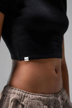 Detail Front View of Black the TLF GTS Cropped Baby Tee features sporty raglan sleeves, cropped length and premium whip stitch detailing. 