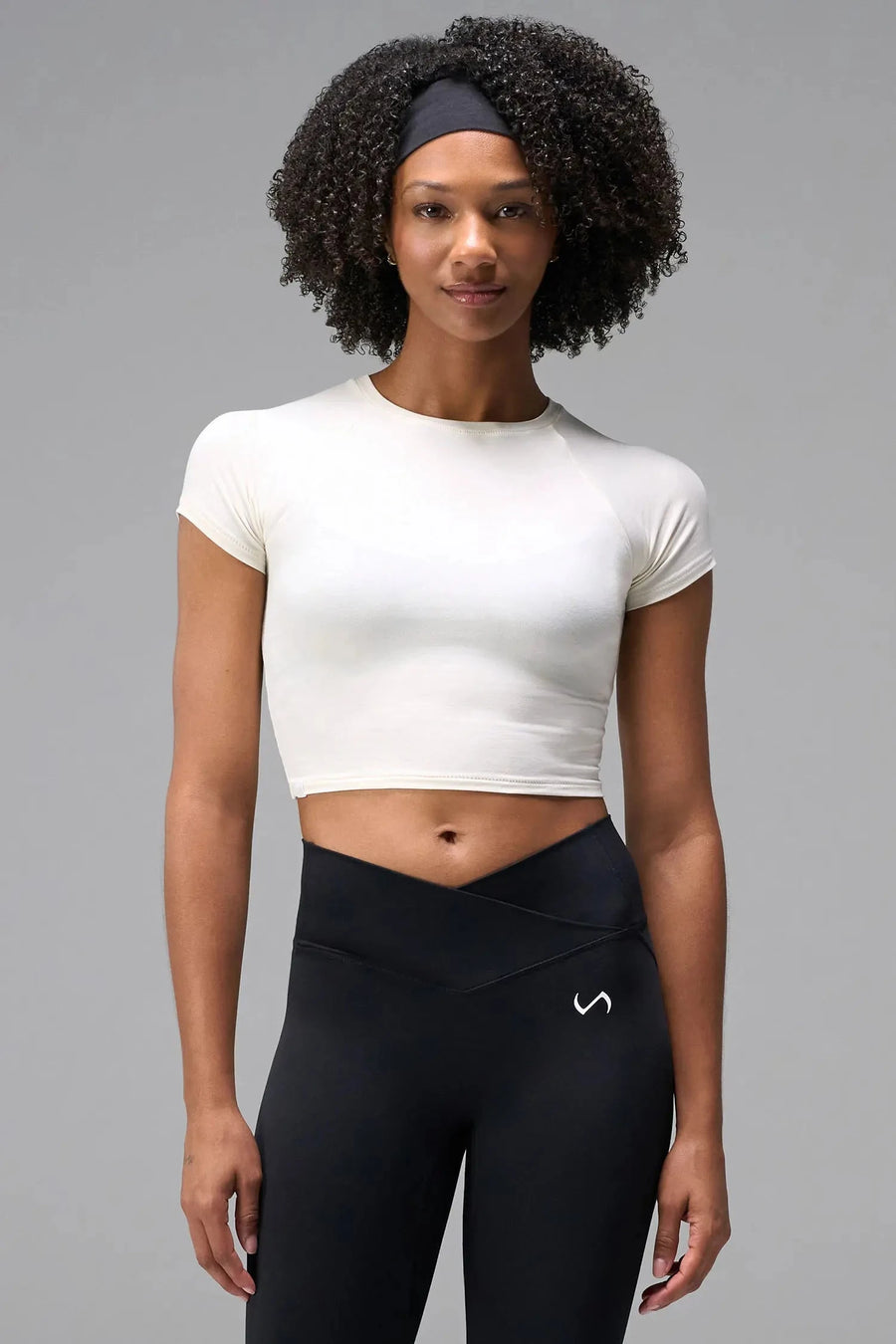 Front View of White the TLF GTS Cropped Baby Tee features sporty raglan sleeves, cropped length and premium whip stitch detailing. 