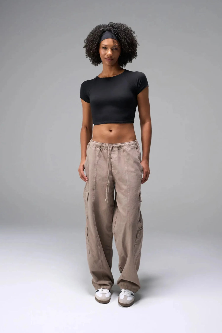 Front View of Black the TLF GTS Cropped Baby Tee features sporty raglan sleeves, cropped length and premium whip stitch detailing. 