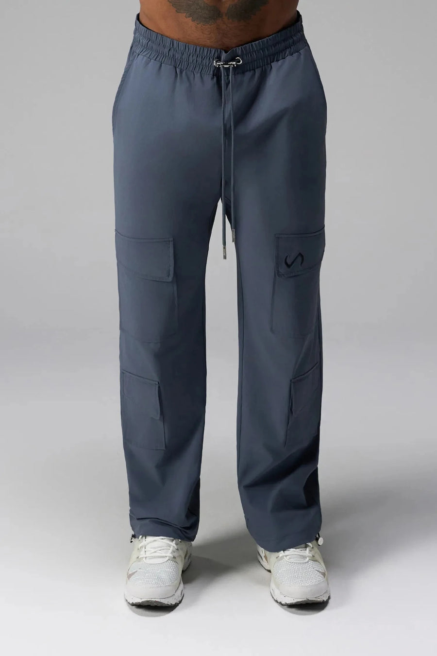 Front View of Blue the TLF GTS Element-Max Cargo Pants featuring front cargo pockets and an adjustable ankle drawcord ankle for custom fit