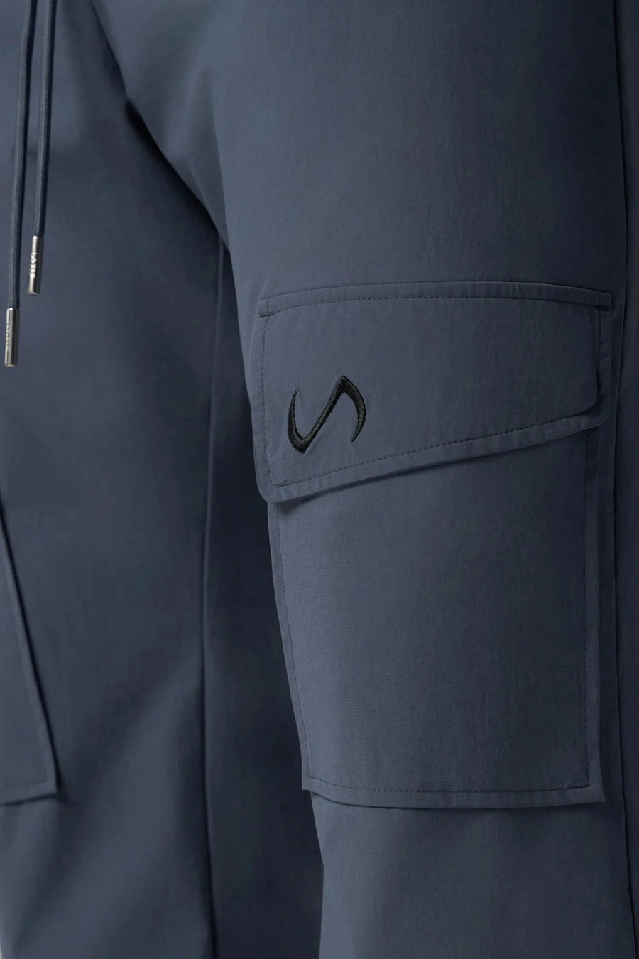 Detail View of Blue the TLF GTS Element-Max Cargo Pants featuring front cargo pockets and an adjustable ankle drawcord ankle for custom fit