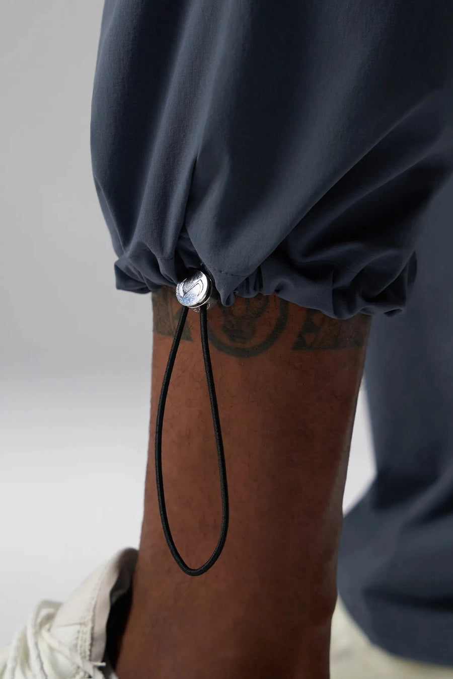 Detail View of Blue the TLF GTS Element-Max Cargo Pants featuring front cargo pockets and an adjustable ankle drawcord ankle for custom fit