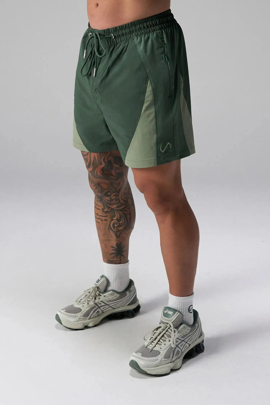 Side View of Green the TLF GTS Element-Max Shorts featuring contrast color panels and sleek invisible side zipper pockets