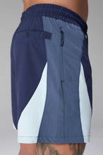 Side View of Blue the TLF GTS Element-Max Shorts featuring contrast color panels and sleek invisible side zipper pockets