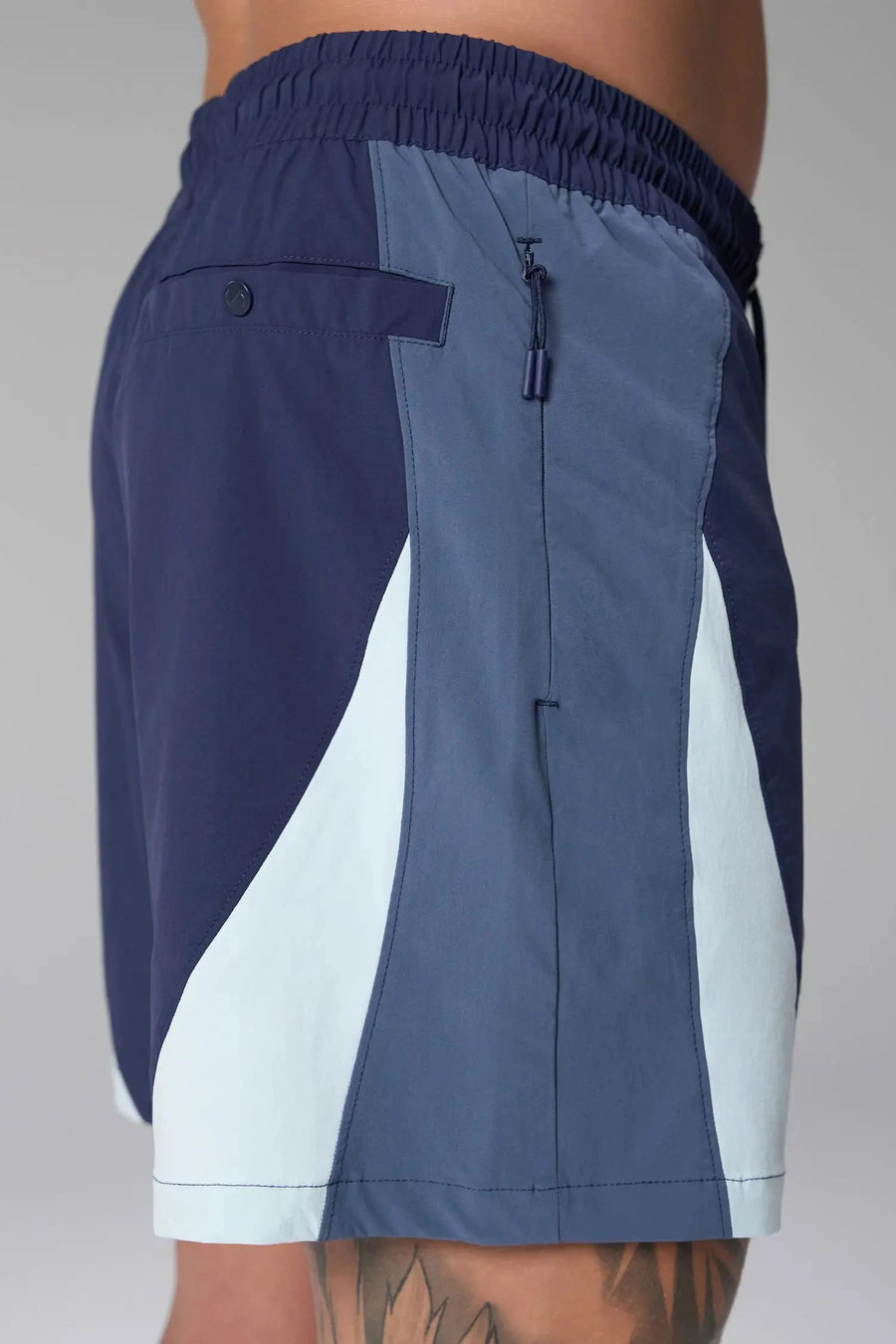 Side View of Blue the TLF GTS Element-Max Shorts featuring contrast color panels and sleek invisible side zipper pockets