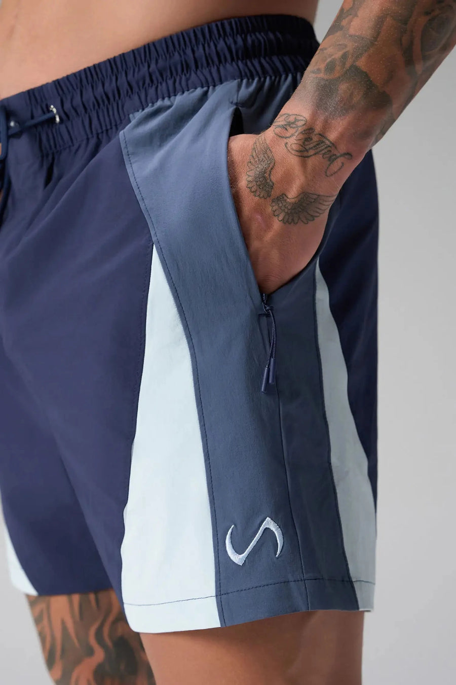Detail Front View of Blue the TLF GTS Element-Max Shorts featuring contrast color panels and sleek invisible side zipper pockets