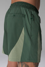 Side View of Green the TLF GTS Element-Max Shorts featuring contrast color panels and sleek invisible side zipper pockets