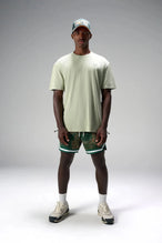 Front View of Green GTS Evolve Mesh 6 Inch Shorts, featuring university of Miami inspired patch paisley design and zipper pockets