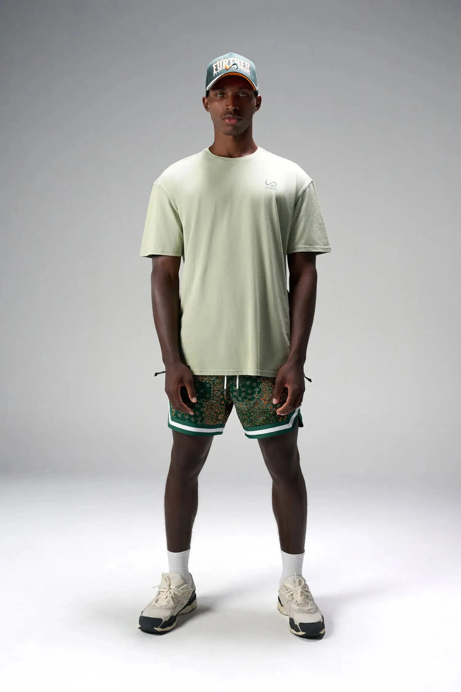 Front View of Green GTS Evolve Mesh 6 Inch Shorts, featuring university of Miami inspired patch paisley design and zipper pockets