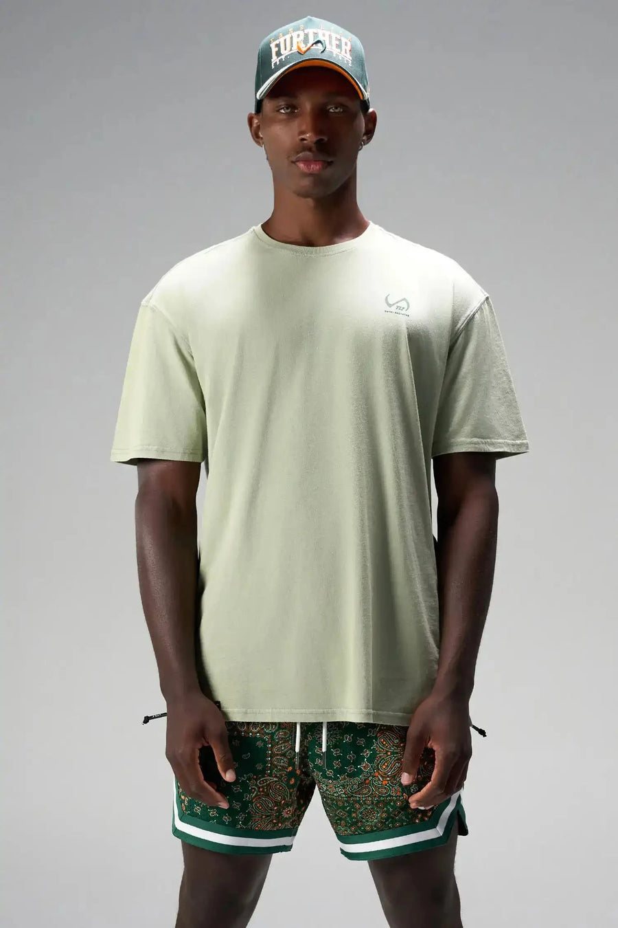 Front View of Green GTS Evolve Mesh 6 Inch Shorts, featuring university of Miami inspired patch paisley design and zipper pockets