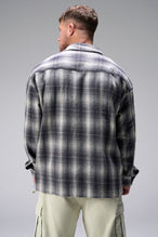 Back View of the Black TLF GTS Flannel Shacket crafted in premium cotton plaid flannel with elevated embroidery details on the collar and back